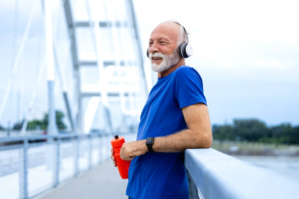 istock Senior sporty man relaxing after running training. 2163415927