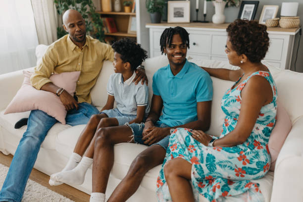 istock Family on the couch having a joyful conversation at home 2163416361