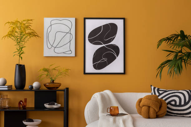 istock Interior design of cozy living room with mock up poster frame, boucle sofa, patterned pillows, black rack, wooden coffee table, vase with flowers and personal accessories. Home decor. Template. 2163417921