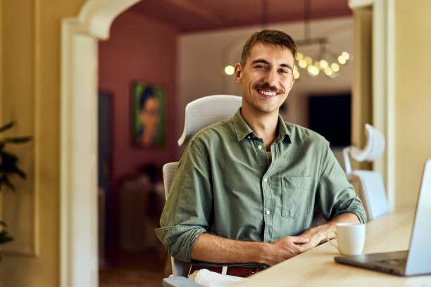 istock A smiling man working at the office, posing for the camera, dressed elegantly. 2163418164