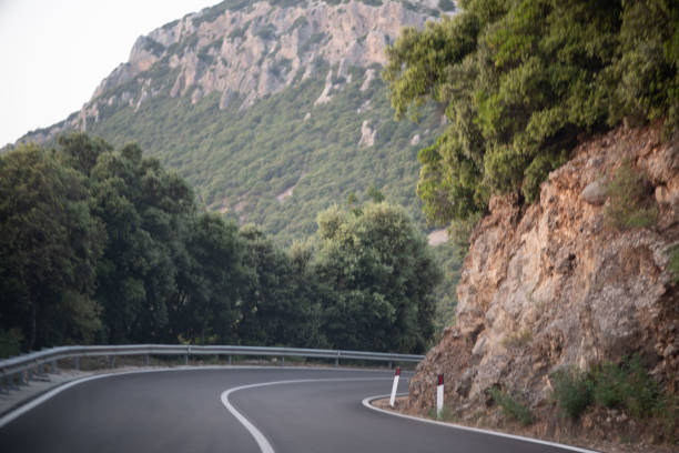 istock Winding Mountain Road meanders through a picturesque setting with greenery and scenic beauty 2163418789