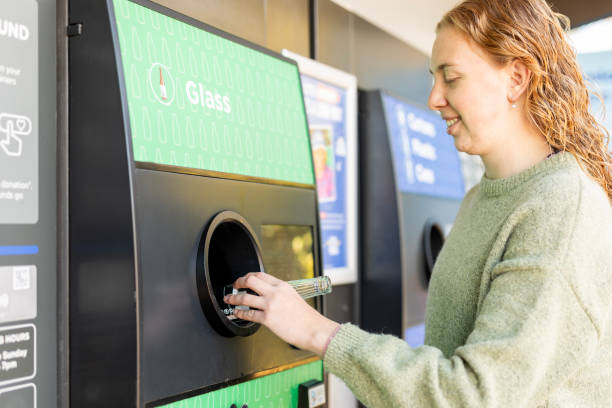 istock Young woman using a bottle recycling machine 2163427468