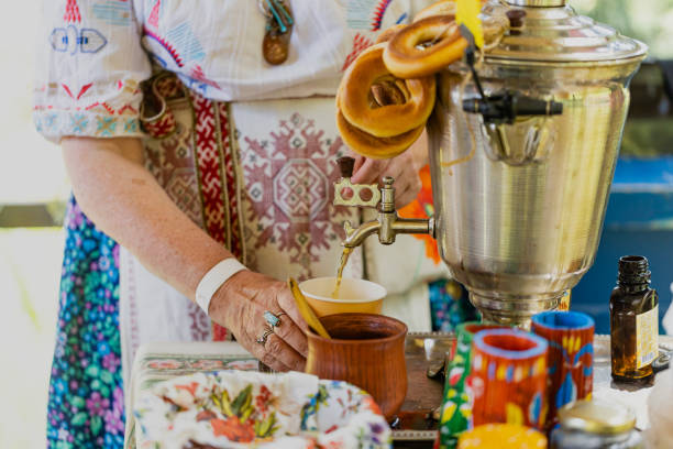 Copper samovar with white teapots and cup of herbal tea