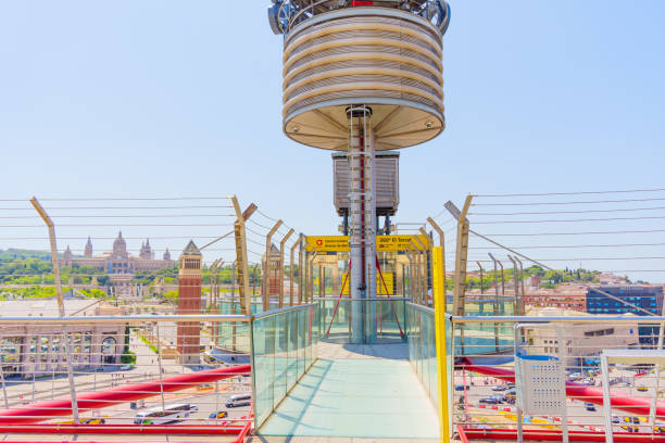 Barcelona, Spain - July 16, 2024: Clear view of the unique elevator shaft with city in the background seen from rooftop of the Arenas de Barcelona Shopping Center.