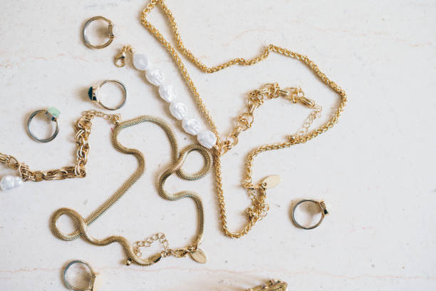 istock Gold jewellery on a marble surface 2163433169