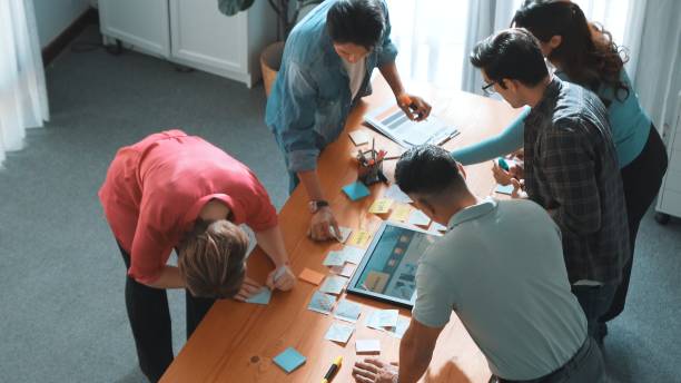istock Top view of manager writing idea on sticky notes and explain idea. Symposium. 2163437814