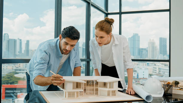 istock Cooperative engineer team working together to measure house model. Tracery 2163440122