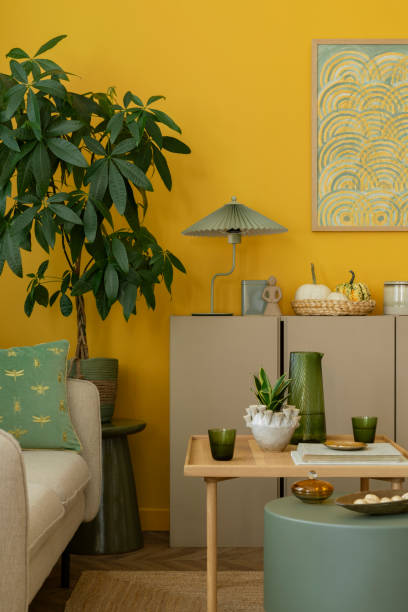 istock Creative composition of living room interior with mock up poster frame, green coffee table, beige sideboard, dried flowers, plants in flowerpots and personal accessories. Home decor. Template. 2163440533