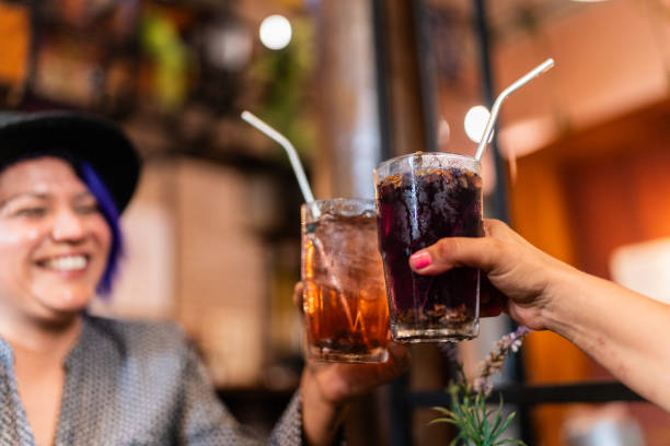 Close-up of friends toasting drinks at restaurant