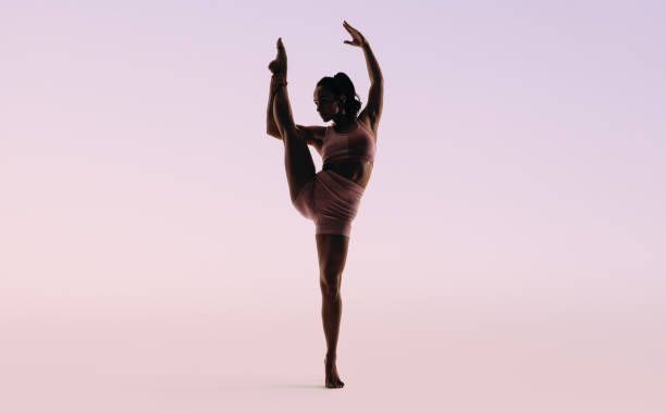 istock Female gymnast performing an impressive one leg pose in a studio 2163443917
