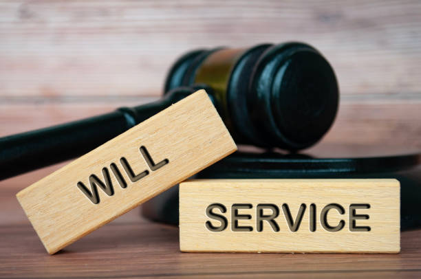 istock Will service text engraved on wooden blocks with lawyer gavel background 2163444844