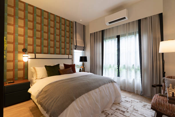 istock Brown bedroom with a headboard and modern carpet and side table lamps. 2163445719