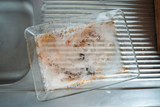 istock Dirty Glass Tray Being Cleaned in Kitchen Sink 2163445727
