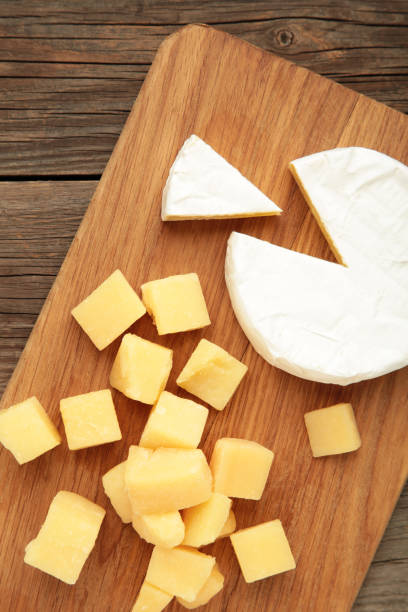 istock Parmesan cheese with camembert on cutting board. Vertical photo 2163445848
