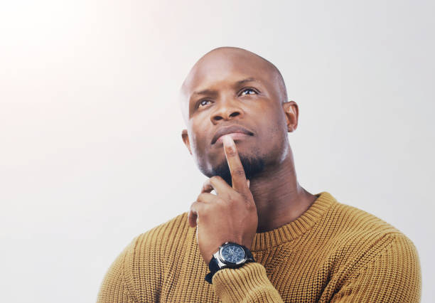 istock Black man, thinking and question with choice, decision or pondering in studio on a white background. Young African, male person or model in wonder, thought or contemplating for option, choose or pick 2163447461