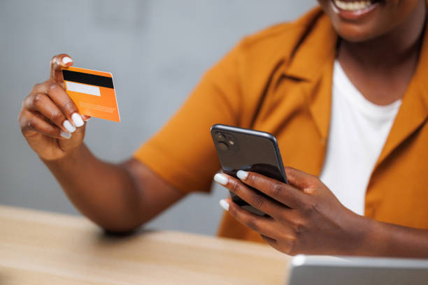 istock Young woman making a payment with a credit card 2163448336