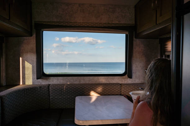 istock Woman having breakfast facing motorhome window 2163453444