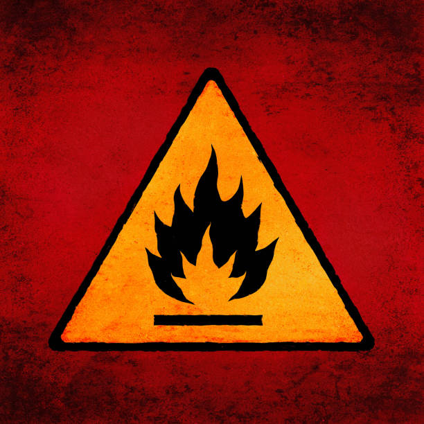 Flammable sign on scratched background. Fire hazard symbol, grunge textured. Conflagration risk icon (triangle), yellow on red