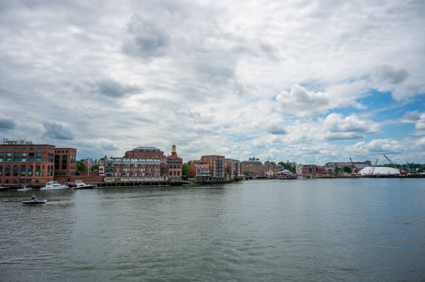 Piscataqua river from Memorial bridge in Portsmouth, New Hampshire, during summer day with boats and houses