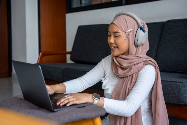 istock Malay woman with headscarf using laptop for video conference 2163454642