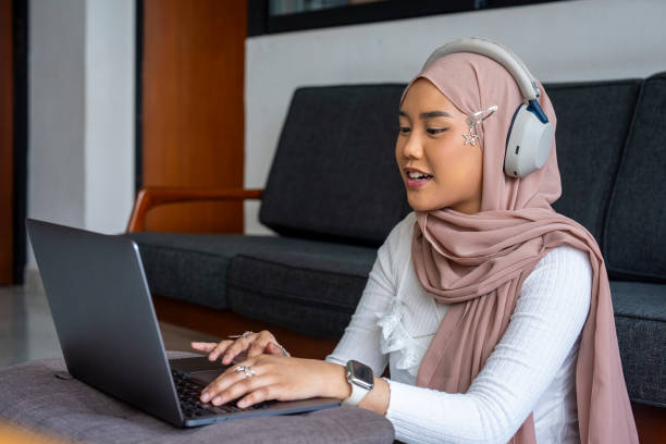 istock Malay woman with headscarf using laptop for video conference 2163454647