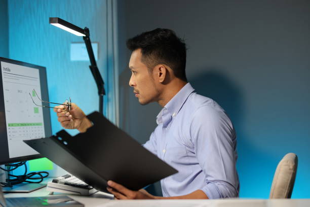 istock Serious businessman working overtime in the office. 2163457388