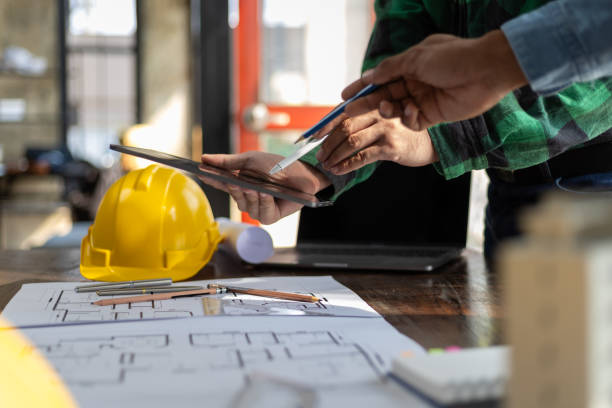 istock Construction and structure concept planning of Engineer or architect meeting for project working with partner and engineering on model building and blueprint in working site. 2163457444