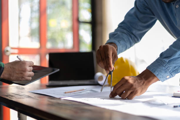istock Construction and structure concept planning of Engineer or architect meeting for project working with partner and engineering on model building and blueprint in working site. 2163457463
