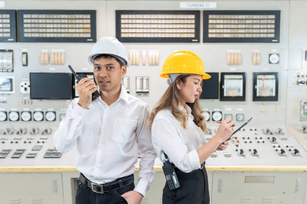 istock Working together, Asian male and female engineers play a key role in developing and deploying cutting-edge solutions in power plants and industrial plants. In the control room there is a switch panel. 2163458744
