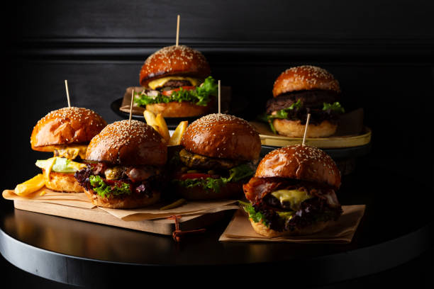istock Set of different burgers on a black table 2163462955