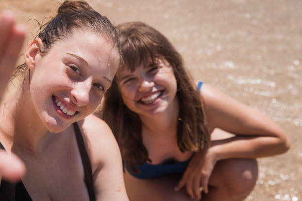 istock Happy girls smiling when taking a selfie 2163463080
