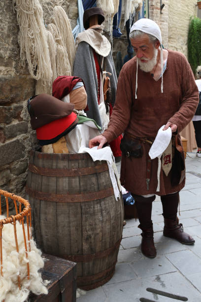 Bevagna, Italy - June 29, 2024: The Umbrian fair, Mercato Delle Gaite, that takes place yearly in the typical village of Bevagna. A hat seller in his shop.