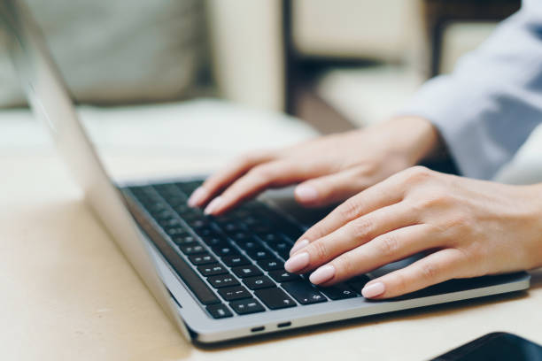 istock Close-up of woman's hands typing on a laptop 2163466018