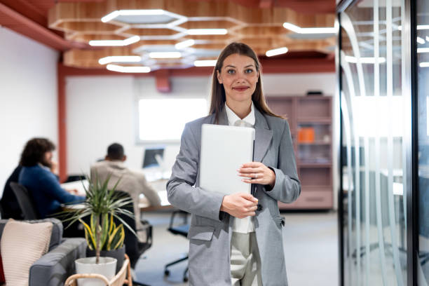 istock Smiling businesswoman posing in modern office 2163466026