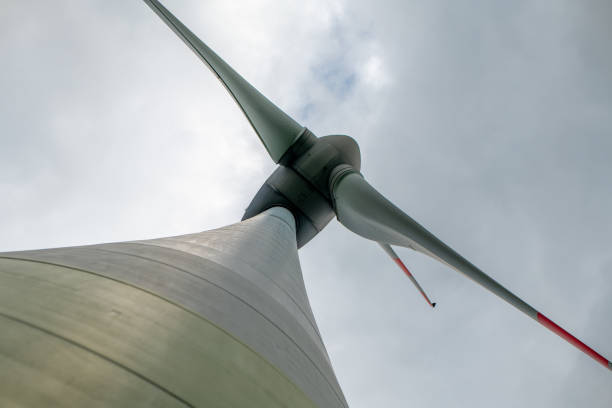 istock wind turbine is shown from the side with its blades spinning in the wind 2163466196