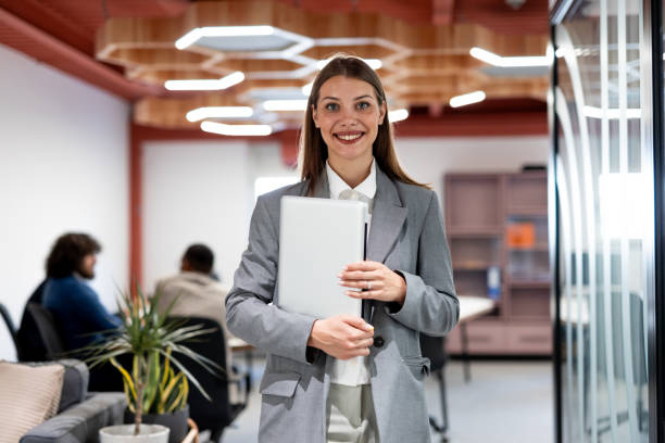 istock Smiling businesswoman posing in modern office 2163466306