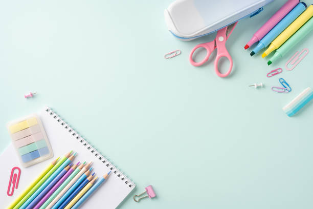 istock Colorful school stationery items including notebooks, pencils, and scissors on a light pastel background 2163467544