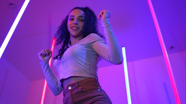 istock Low angle camera of hispanic dancer looking at camera and dancing. Regalement. 2163467990