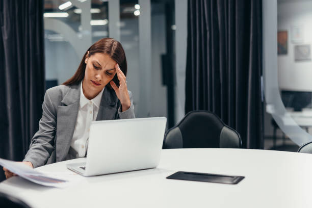 istock Worried business woman having headache at work 2163469129