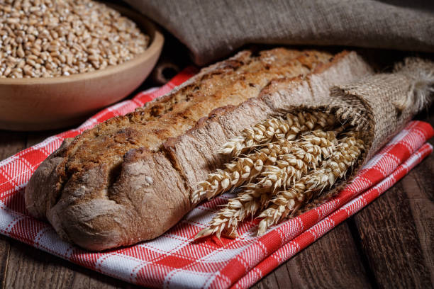 istock Assortment of baked bread on wooden table background 2163470263