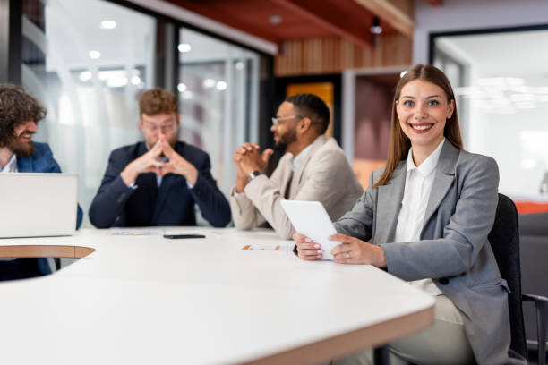 istock Smiling businesswoman posing in modern office 2163470431