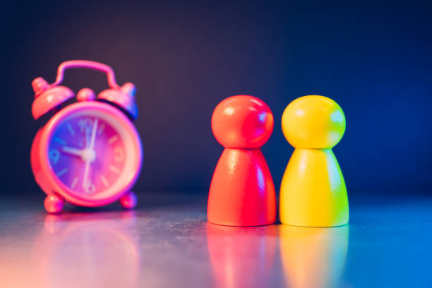 istock Closeup wooden people with clock background 2163470890