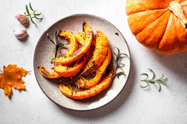 istock Roasted pumpkin slices with garlic and herbs 2163470893