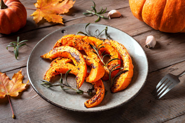 istock Roasted pumpkin slices with garlic and herbs 2163470903