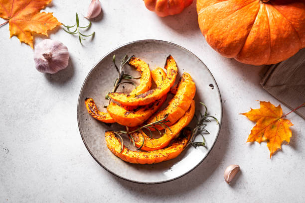 istock Roasted pumpkin slices with garlic and herbs 2163470919