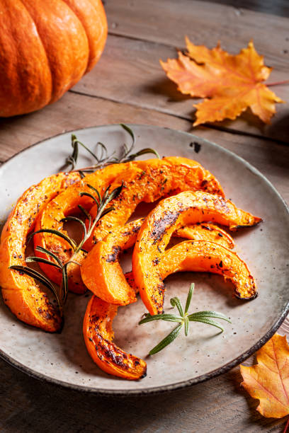 istock Roasted pumpkin slices with garlic and herbs 2163471092