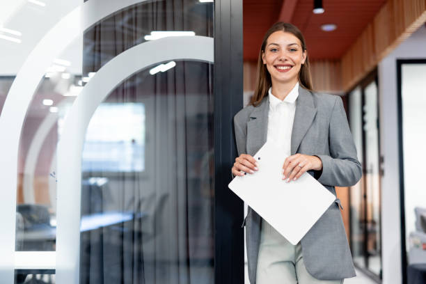 istock Smiling businesswoman posing in modern office 2163471178