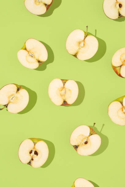 istock Pattern of apples on a light green background. Summer or fall fruit, delicious and healthy snack. Creative food concept 2163479097