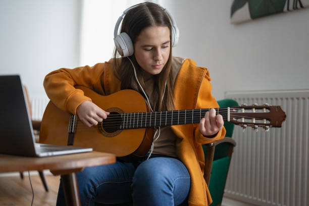 istock Focused Beginner Guitarist Practices at Home 2163480058
