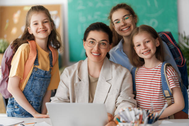 istock Happy kids and teacher at school 2163480178